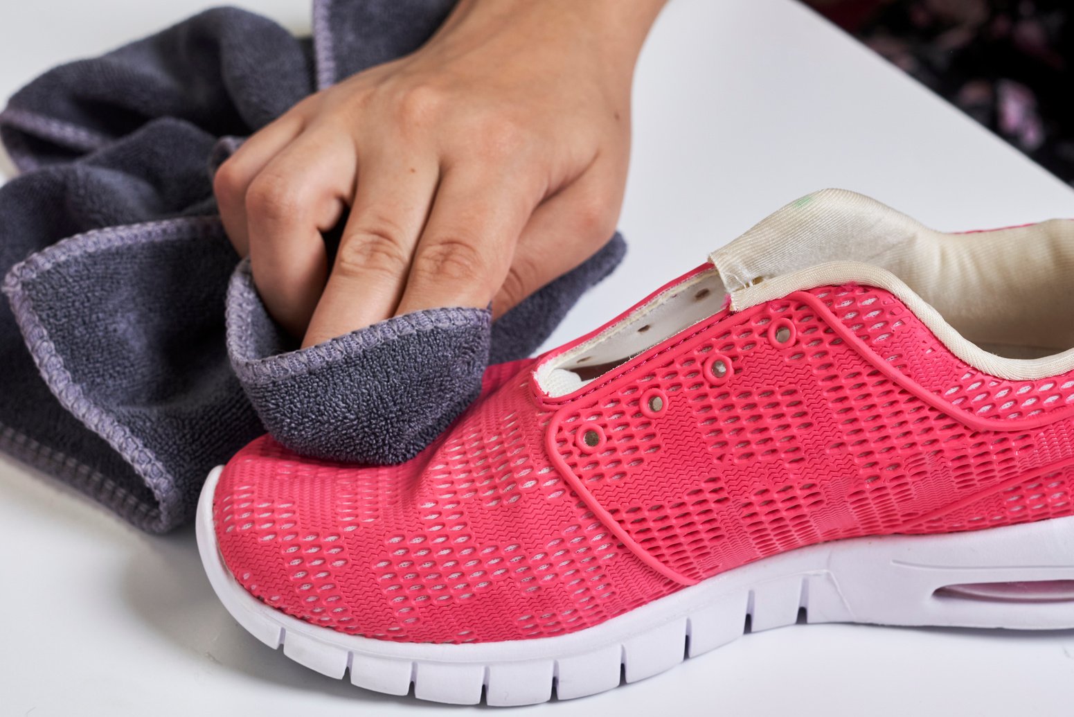 Woman cleans sport shoes